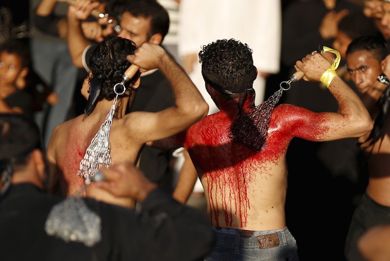 Saudi Shi'ite Muslims flagellate themselves with chains during an Ashura procession in Qatif, east Saudi Arabia, October 24, 2015. Ashura, which falls on the 10th day of the Islamic month of Muharram, commemorates the death of Imam Hussein, grandson of Prophet Mohammad, who was killed in the 7th century battle of Kerbala. Photo courtesy REUTERS/Faisal Al Nasser