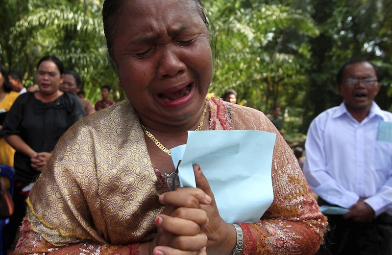 A resident cries as she prays during a Sunday mass near a burned church in Aceh Singkil, Indonesia. Photo by Y.T. Haryono courtesy of Reuters. 