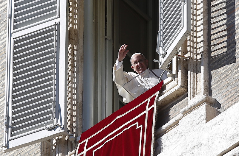 Pope Francis waves during his Sunday Angelus prayer in Saint Peter's Square at the Vatican on Nov. 8, 2015. Photo courtesy REUTERS/Alessandro Bianchi