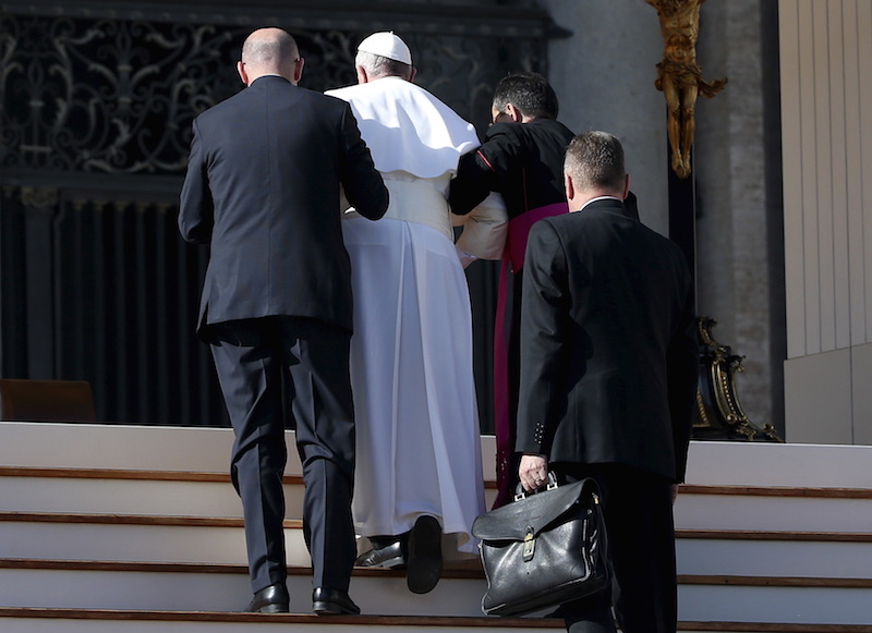 Pope Francis receives help after slipping as he arrives to lead the audience with national Italian insurance body in Saint Peter's Square at the Vatican, November 7, 2015. Photo courtesy REUTERS/ Alessandro Bianchi     