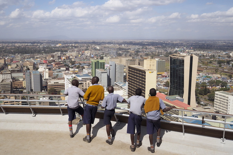 Schoolchildren look out at the central business district from atop the Kenya International Convention Centre in Nairobi, Kenya, August 25, 2015. Photo courtesy REUTERS/Joe Penney