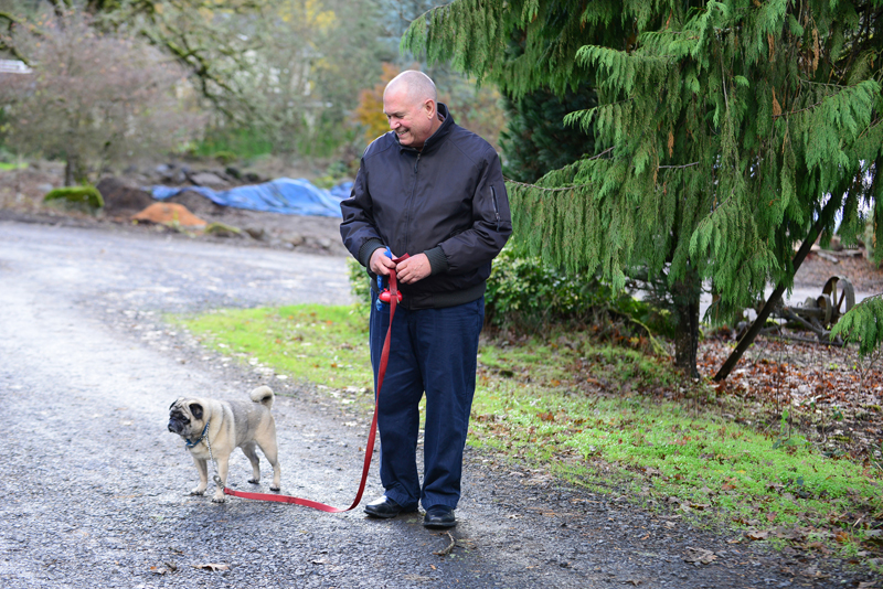 Dr. Peter Rasmussen, a retired medical oncologist who led the Death With Dignity movement and defended the Oregon law in the U.S. Supreme Court, takes his dog, Pugsley, for a walk around their East Salem neighborhood on Dec. 3, 2014. Photo by Danielle Peterson/Statesman Journal, courtesy of USA Today
