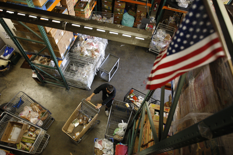 Workers fill carts with food for the poor at the Foothill Unity Center food bank in Monrovia, California, on November 14, 2012. Photo courtesy of REUTERS/David McNew *Editors: This photo may only be republished with RNS-HUNGER-POVERTY, originally transmitted on Nov. 23, 2015.