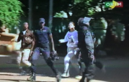 Still image from video show a hostage rushed out from the Radisson hotel in Bamako, Mali, November 20, 2015. Gunmen shouting Islamic slogans attacked a luxury hotel full of foreigners in Mali's capital Bamako early on Friday morning, taking 170 people hostage, a senior security source and the hotel's operator said. Image courtesy of Reuters TV