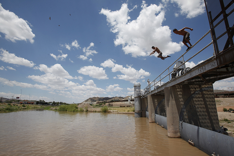 Two men jump to into the Rio Grande to cool off during a hot summer day at the border crossing between Mexico and the United States in Ciudad Juarez, Mexico, on June 28, 2015. Photo courtesy of REUTERS/Jose Luis Gonzalez 
*Editors: This photo may only be republished with RNS-POPE-BORDER, originally transmitted on Nov. 4, 2015.