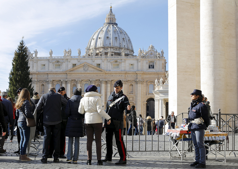 Italian Carabinieri officers check a person before Pope Francis' Sunday Angelus prayer in St.Peter's square at the Vatican, on November 22, 2015. Photo courtesy of REUTERS/Alessandro Bianchi *Editors: This photo may only be republished wth RNS-VATICAN-TRIAL, originally transmitted on Nov. 23, 2015.