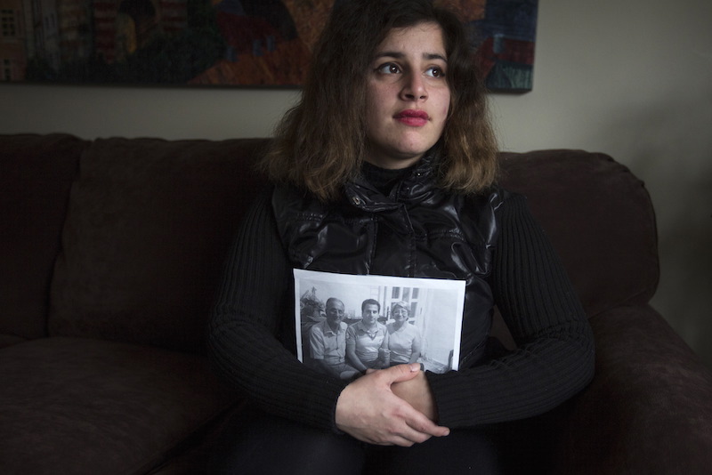 Recent refugee from Syria Sandy Khabbazeh poses for a portrait while holding a photo of her family who remain behind in Syria, in Oakland, N.J.  Picture taken November 22, 2015. Photo courtesy REUTERS/Carlo Allegri  