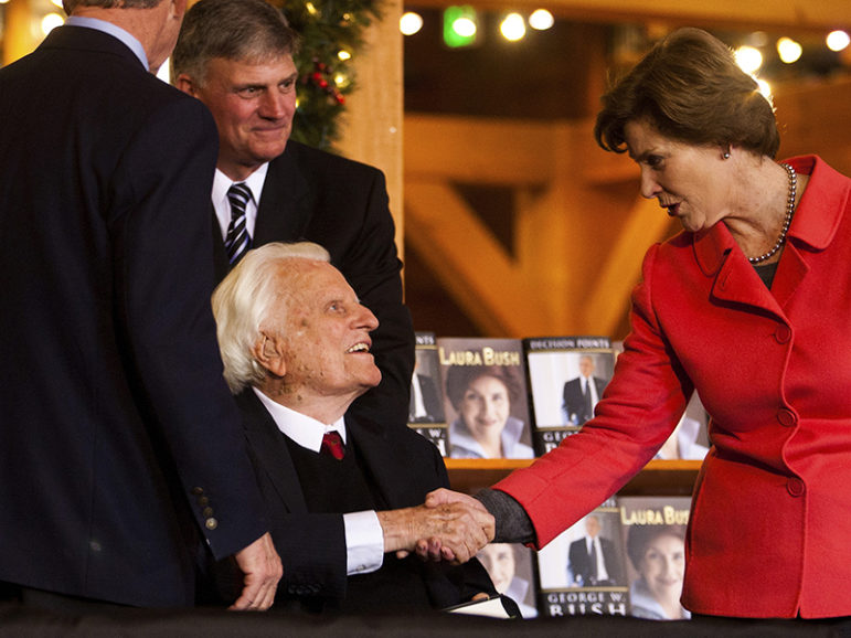 Billy Graham, center, shakes hands with Laura Bush at the Billy Graham Library in Charlotte, N.C., on Dec. 20, 2010. Photo courtesy of REUTERS/Chris Keane