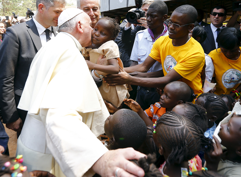 Pope Francis kisses a child as he visits the refugee camp of Saint Sauveur in the capital Bangui, Central African Republic, on November 29, 2015. Photo courtesy of REUTERS/Stefano Rellandini *Editors: This photo may only be republished with RNS-JUBILEE-AFRICA, originally transmitted on December 21, 2015.