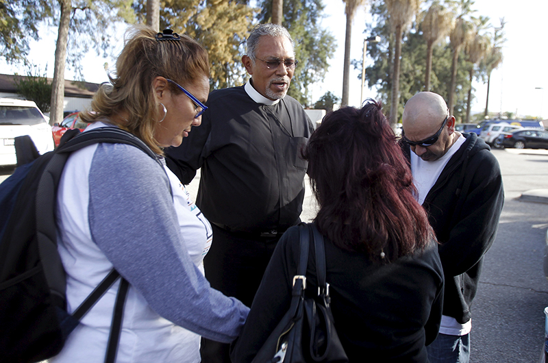 Chaplain Rob Reyes, second left, prays with relatives of a worker who was not injured, but expected at the Rudy Hernandez Community Center, after a shooting incident at the Inland Regional Center in San Bernardino, California on December 2, 2015. Photo courtesy of REUTERS/Alex Gallardo
*Editors: This photo may only be republished with RNS-MERRITT-COLUMN, originally transmitted on Dec. 3, 2015.