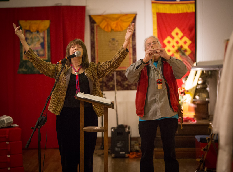 The Rev. Kara Hawkins, left, and the Rev. Lee Slusher (Stumbling Deer) perform a Native American purification song during the World Peace Meditation, an interfaith gathering, at the Rime Buddhist Center in Kansas City, Mo., on Dec. 31, 2015. Religion News Service photo by Sally Morrow