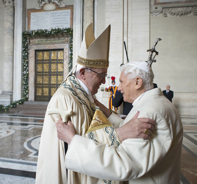 Pope Francis embraces Emeritus Pope Benedict XVI before opening the Holy Door to mark opening of the Catholic Holy Year, or Jubilee, in St. Peter's Basilica, at the Vatican, on Dec. 8, 2015. (Photo by Osservatore Romano/Handout via AP)
