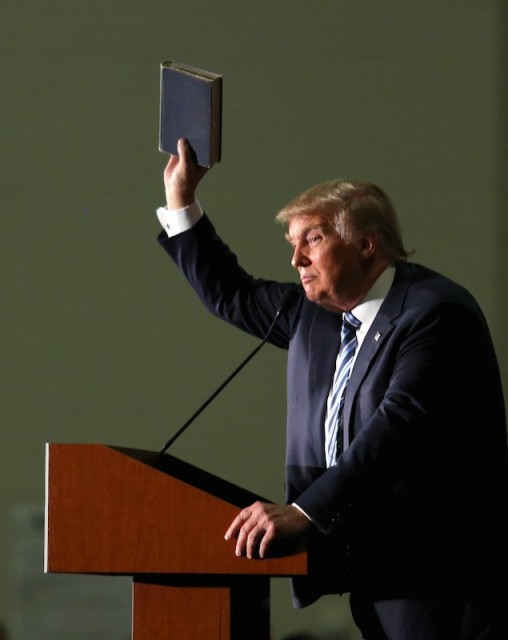 Republican presidential candidate Donald Trump holds up a copy of the Bible he said his mother gave him as a youth during a campaign rally in Council Bluffs, Iowa, on Dec. 29, 2015. Photo by Lane Hickenbottom/Reuters