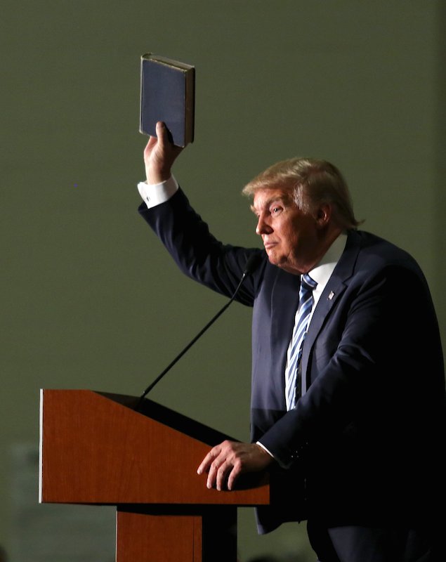 U.S. Republican presidential candidate Donald Trump holds up a copy of the Bible he said his mother gave him as a youth during a campaign rally in Council Bluffs, Iowa, on December 29, 2015. Photo courtesy of REUTERS/Lane Hickenbottom *Editors: This photo may only be republished with RNS-TRUMP-LIBERTY, originally transmitted on Jan. 5, 2016.