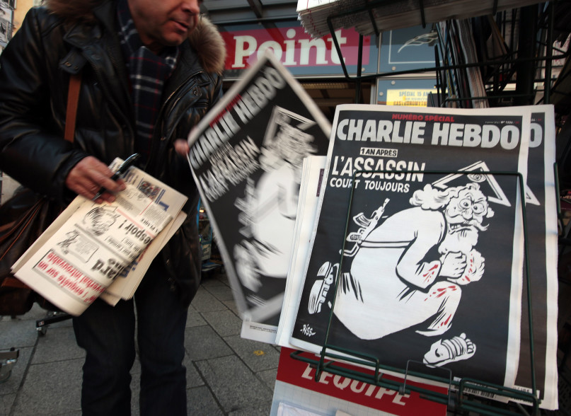 A man takes a copy of the latest edition of French weekly newspaper Charlie Hebdo with the title 