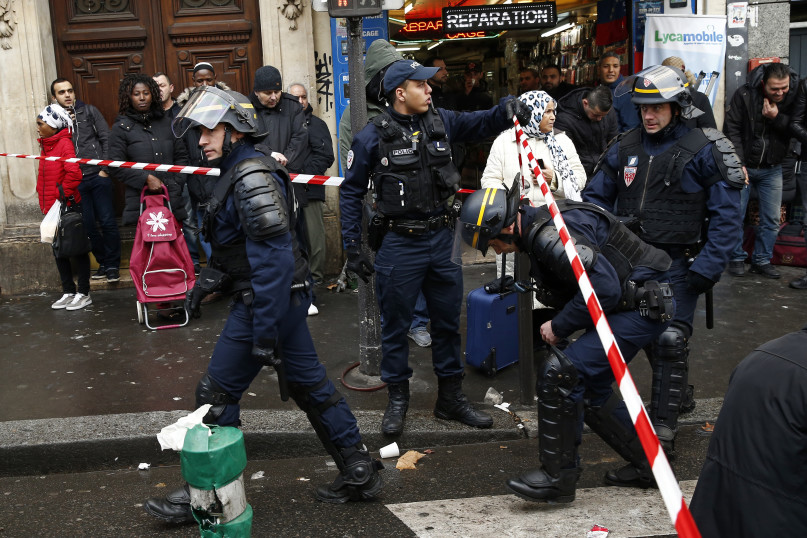 French police secure the area after a man was shot dead at a police station in the 18th district in Paris, France, January 7, 2016. Police in Paris on Thursday shot dead a knife-wielding man who tried to enter a police station, police union sources said. The incident took place on the anniversary of last year's deadly Islamist militant attacks on the Charlie Hebdo satirical magazine in the French capital.  REUTERS/Benoit Tessier.