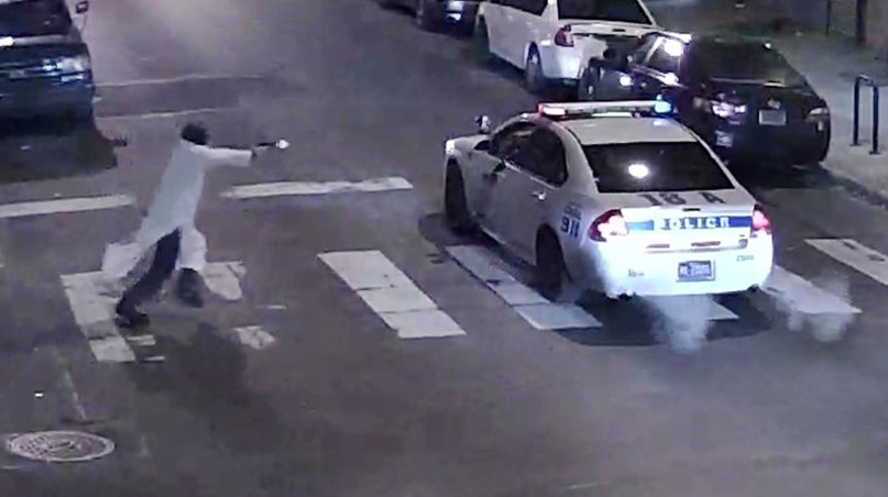 A still image from surveillance video shows a gunman approaching a Philadelphia Police vehicle in which Officer Jesse Hartnett was shot shortly before midnight January 7, 2016 in Philadelphia. Police Department image released on January 8, 2016.   REUTERS/Philadelphia Police Department/Handout.