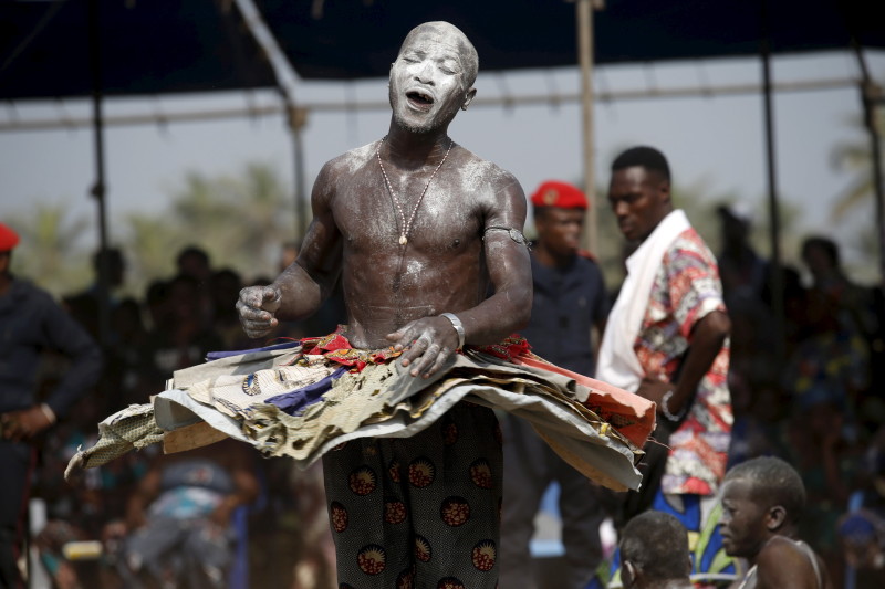 A devotee dances at the annual voodoo festival in Ouidah January 10, 2016. The national voodoo holiday in the West African country of Benin had a distinctively political accent this year as practitioners from Africa and the Americas gathered on Sunday to offer prayers and sacrifices for peace. REUTERS/Akintunde Akinleye.