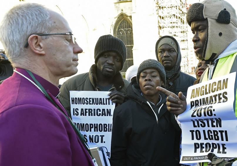 Archbishop of Canterbury Justin Welby, left, speaks with protesters on the grounds of Canterbury Cathedral in Canterbury, England, on Jan. 15, 2016. REUTERS/Toby Melville.