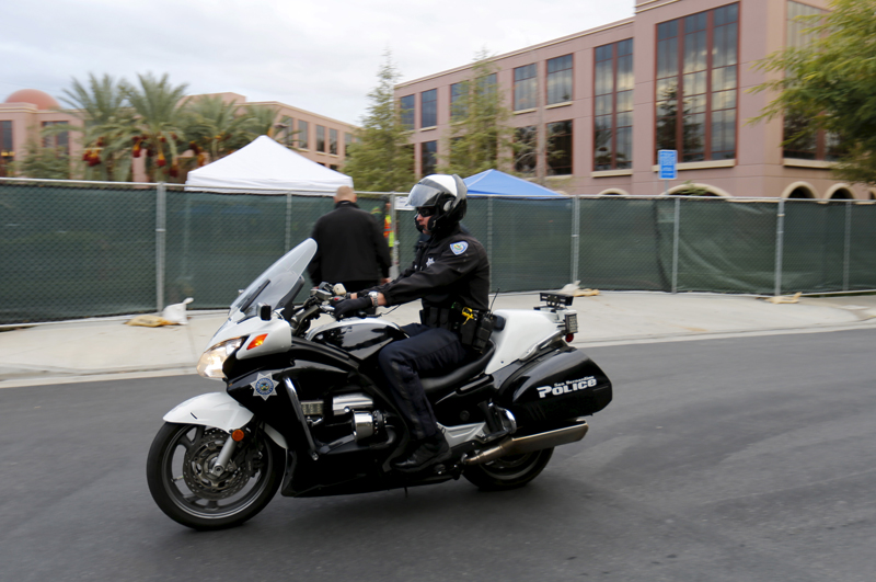 A police officer passes by on a motorcycle as employees return to work for the first time following a shooting at the Inland Regional Center (IRC) in San Bernardino, California on January 4, 2016. Just over a month ago, 14 people were shot and killed at the center. Photo courtesy of REUTERS/Mike Blake 
*Editors: This photo may only be republished with RNS-POLICE-EXTREMISTS, originally transmitted on Jan. 14, 2015.