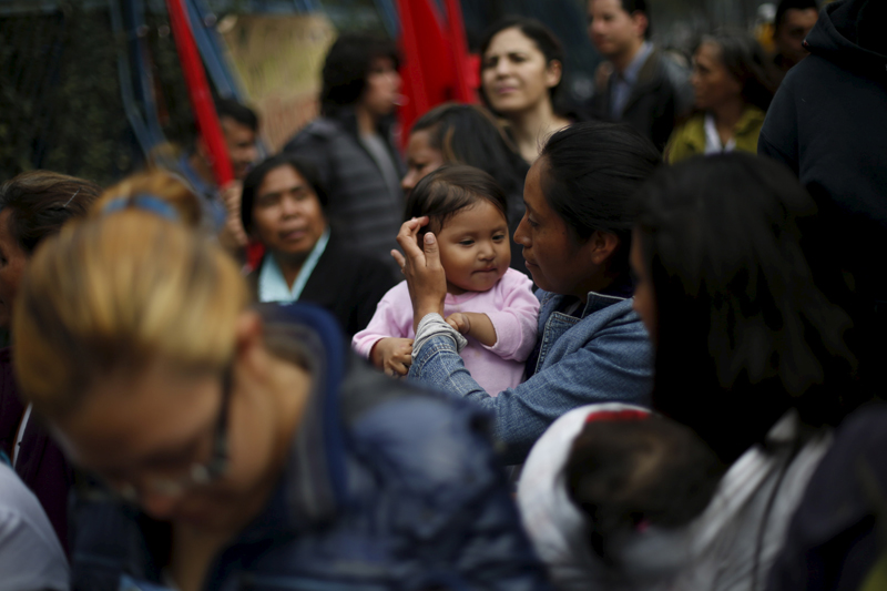 A mother and her baby take part during a demonstration for the rights of refugees migrants near the U.S. embassy building in Mexico City, on December 18, 2015. Photo courtesy of REUTERS/Edgard Garrido
*Editors: This photo may only be republished with RNS-SALKIN-COLUMN, originally transmitted on Jan. 5, 2016.