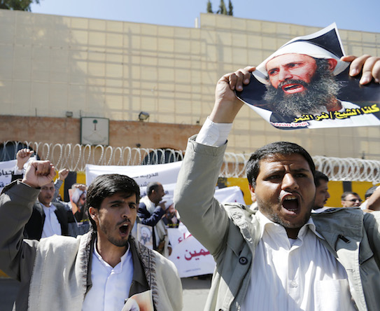 Shi'ite protesters carry posters of Sheikh Nimr al-Nimr during a demonstration outside the Saudi embassy in Sanaa October 18, 2014. The cleric was executed Jan. 2. REUTERS/Khaled Abdullah 