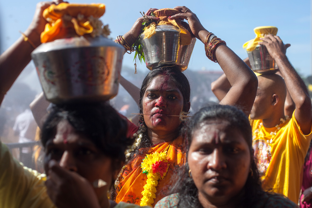 Hindu devotees with their cheeks pierced by skewers carry bowls of milk as offerings during their Thaipusam pilgrimagein Kuala Lumpur, Malaysia on Jan 24, 2016. Religion News Service photo by Alexandra Radu