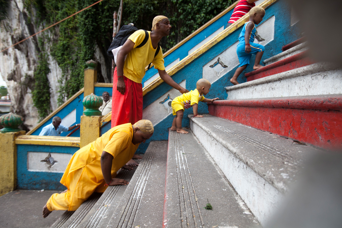 Suguna, far left, fulfills her Thaipusam pilgrimage by climbing the stairs leading to Murugan's shrine on her knees in Kuala Lumpur, Malaysia on Jan 24, 2016. She takes this journey together with her husband and two children. Religion News Service photo by Alexandra Radu