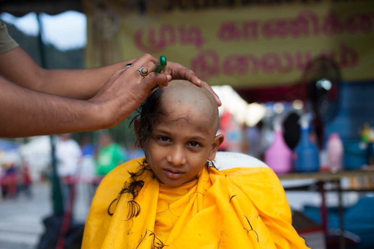 A young Hindu devotee is having her head shaved for cleansing before beginning her Thaipusam pilgrimage in Kuala Lumpur, Malaysia on Jan 24, 2016. Religion News Service photo by Alexandra Radu