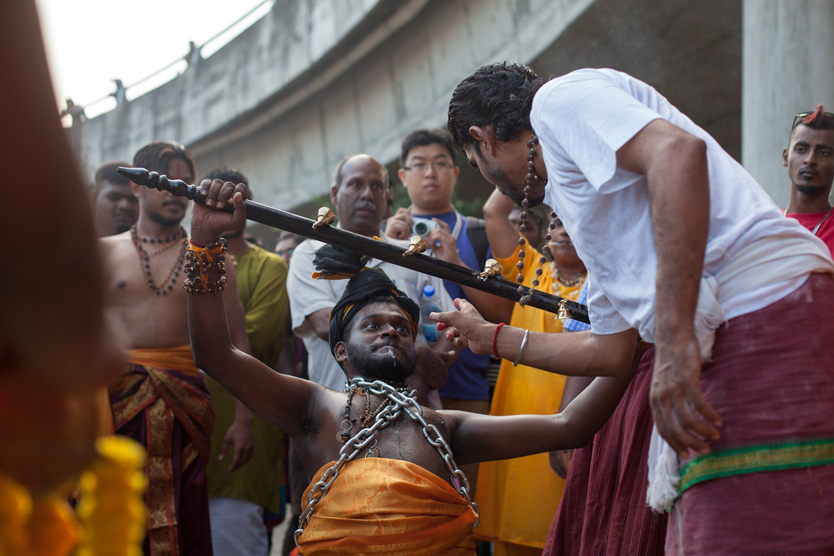 A Hindu devotee is guided by a family member while being in a trance during his Thaipusam pilgrimage in Kuala Lumpur, Malaysia on Jan 24, 2016. Religion News Service photo by Alexandra Radu