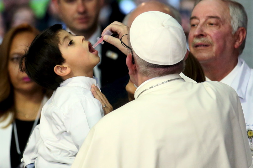 Pope Francis gives medicine to a young patient while visiting pediatric hospital "Federico Gomez" in Mexico City, February 14, 2016. REUTERS/Max Rossi.