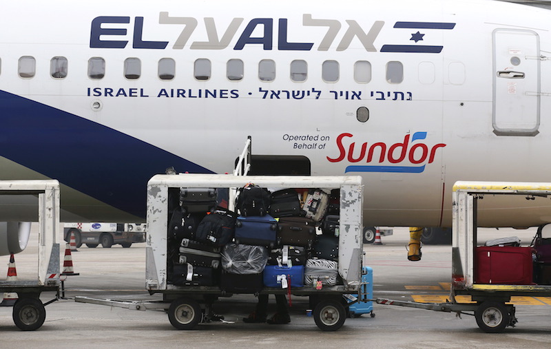 Baggage carts are seen on the tarmac near an El Al Israel Airlines plane at Venice airport February 1, 2016.  Photo courtesy REUTERS/Alessandro Bianchi 