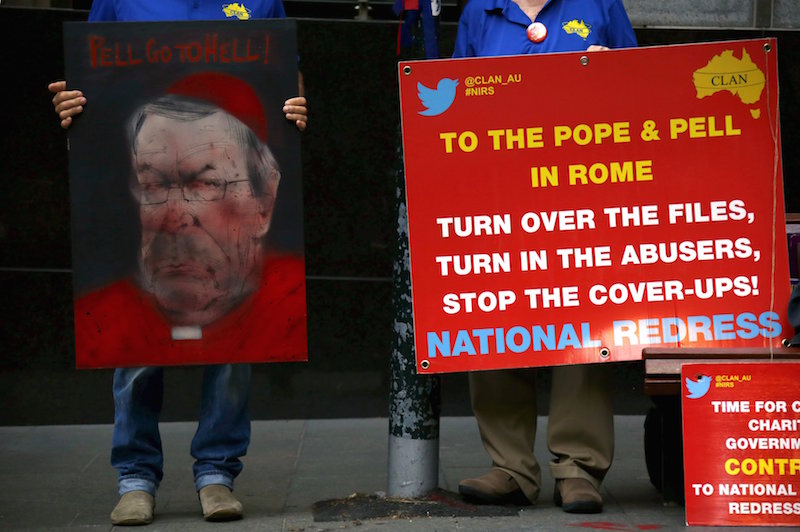 Victims and relatives of children who claim they were sexually abused by the Catholic Church hold placards as they stand outside the venue for Australia's Royal Commission into Institutional Response to Child Sexual Abuse in Sydney, Australia, February 29, 2016. Australian Cardinal George Pell on Monday becomes the highest-ranking Vatican official to testify on sexual abuse of children in the Catholic Church at a hearing that victims have flown half way around the world to attend. REUTERS/David Gray