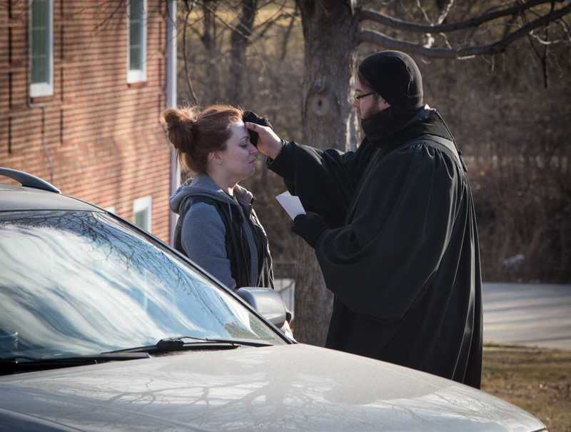 Ministerial intern Shea Zellweger, gives drive thru ashes and a prayer to Antoinette Moretina, from Kansas City, Kan., on Ash Wednesday, Feb. 10, 2016, in Prairie Village, Kan. For the fourth year, Colonial Church, United Church of Christ, is offering drive thru service on Ash Wednesday from 6 a.m. until 9 a.m. Religion News Service photo by Sally Morrow