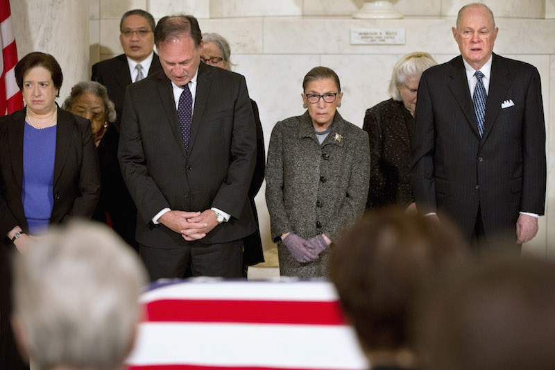 Supreme Court Justices, from left, Elena Kagan, Samuel Anthony Alito, Jr., Ruth Bader Ginsburg, and Anthony Kennedy participate in prayers at a private ceremony in the Great Hall of the Supreme Court where late Supreme Court Justice Antonin Scalia lies in repose in Washington, February 19, 2016. REUTERS/Jacquelyn Martin/POOL - RTX27QG5