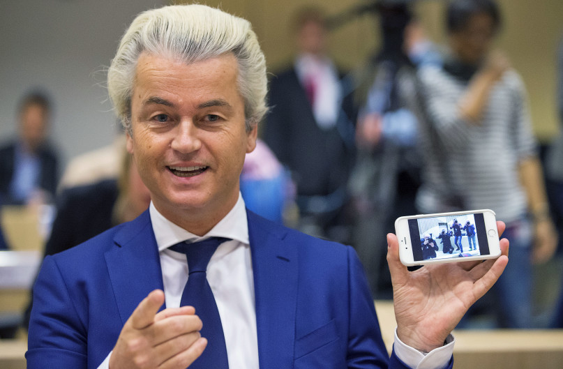 Dutch far-right Party for Freedom (PVV) leader Geert Wilders shows the picture of the photographers he took with his cell phone prior to his trial in the courtroom in the courthouse in Schiphol, the Netherlands March 18, 2016. REUTERS/Michael Kooren.