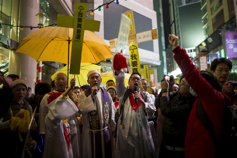 Pro-democracy protesters from a politically active Christian church, hold up yellow umbrellas, a symbol of the Occupy Central civil disobedience movement, as they sing Christmas carols at Times Square in Hong Kong early on December 25, 2014. Photo courtesy of REUTERS/Tyrone Siu *Editors: This photo may only be republished with RNS-CHINA-CHRISTIANS, originally transmitted on March 8, 2016.