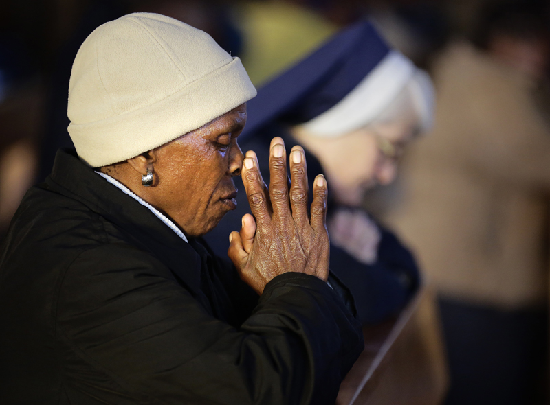 A woman and a nun pray during an early morning mass at Regina Mundi Church in Soweto on June 30, 2013. Photo courtesy of REUTERS/Kevin Coombs
*Editors: This photo may only be republished with RNS-GENDER-RELIGION, originally transmitted on March 22, 2016.