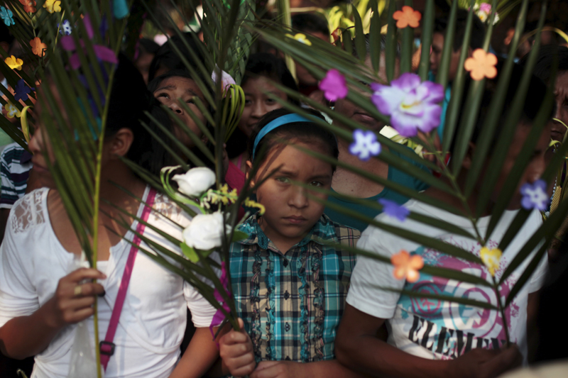 Catholics hold palm fronds during a Palm Sunday celebration in Nahuizalco, El Salvador, on March 20, 2016. Palm Sunday commemorates Jesus Christ's triumphant entry into Jerusalem on the back of a donkey and marks the start of Holy Week. Photo courtesy of REUTERS/Jose Cabezas