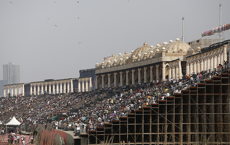 People sit on the steps of a stage at the venue of World Culture Festival on the banks of the Yamuna river in New Delhi, India, on March 10, 2016. Indian environmentalists are aghast that a huge cultural festival is to be held on the floodplain of Delhi's main river from Friday, warning that the event, and the 3.5 million visitors expected, will devastate the area's biodiversity. Photo courtesy of REUTERS/Anindito Mukherjee