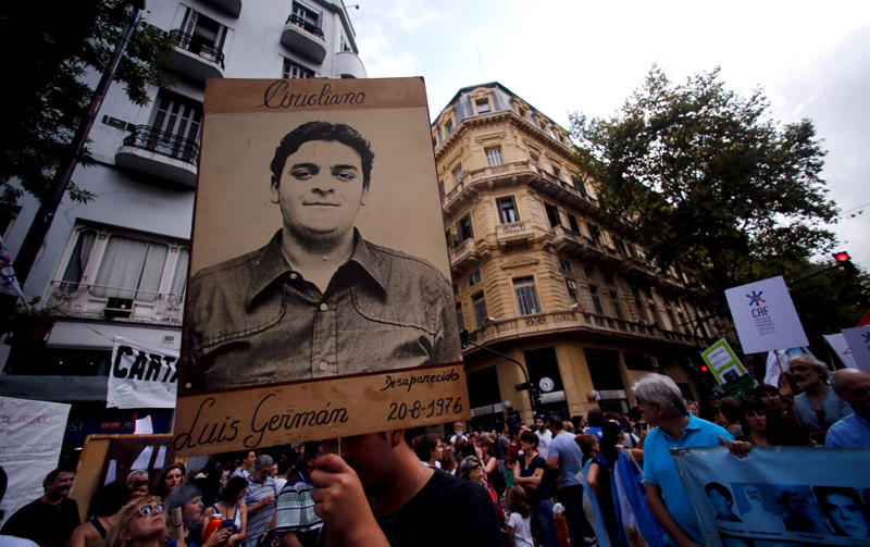 A man holds up a portrait of Luis German Cirigliano, who disappeared during Argentina's 'Dirty war', during a demonstration to commemorate the 40th anniversary of the 1976 military coup in Buenos Aires, on March 24, 2016. Photo courtesy of REUTERS/Marcos Brindicci *Editors: This photo may only be republished with RNS-MORELLO-COLUMN, originally transmitted on March 28, 2016.