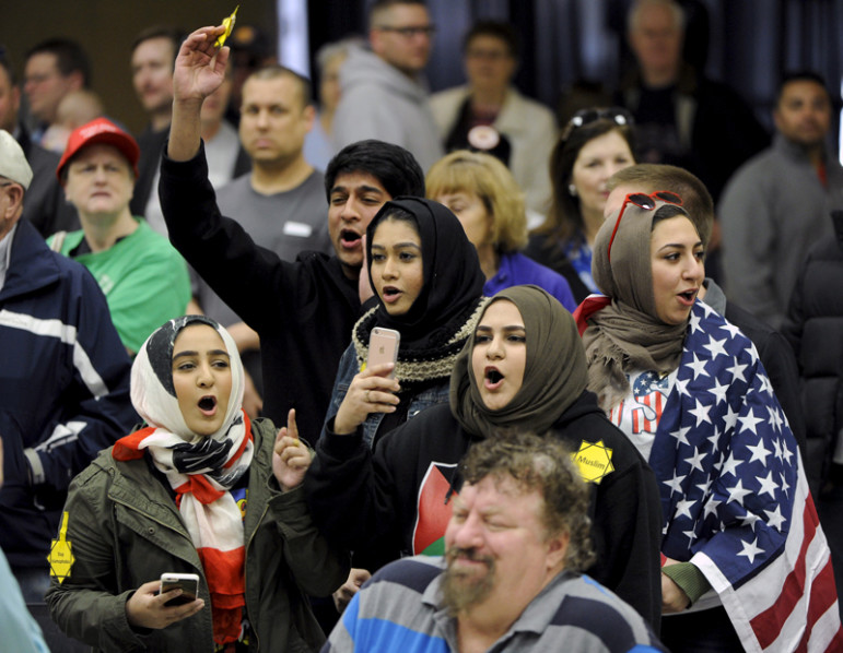 Young Muslims protest Republican presidential candidate Donald Trump before being escorted out during a campaign rally in the Kansas Republican Caucus at the Century II Convention and Entertainment Center in Wichita, Kan., on March 5, 2016. Photo courtesy of REUTERS/Dave Kaup 
*Editors: This photo may only be republished with RNS-MUSLIM-VOTERS, originally transmitted on March 9, 2016.