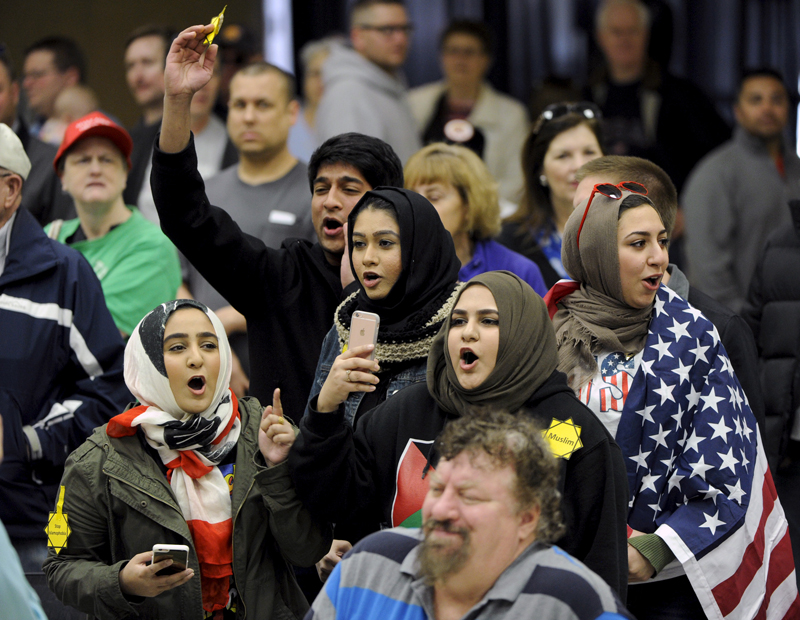 Young Muslims protest U.S. Republican presidential candidate Donald Trump before being escorted out during a campaign rally in the Kansas Republican Caucus at the Century II Convention and Entertainment Center in Wichita, Kansas on March 5, 2016. Photo courtesy of REUTERS/Dave Kaup 
*Editors: This photo may only be republished with RNS-MUSLIM-VOTERS, originally transmitted on March 9, 2016.