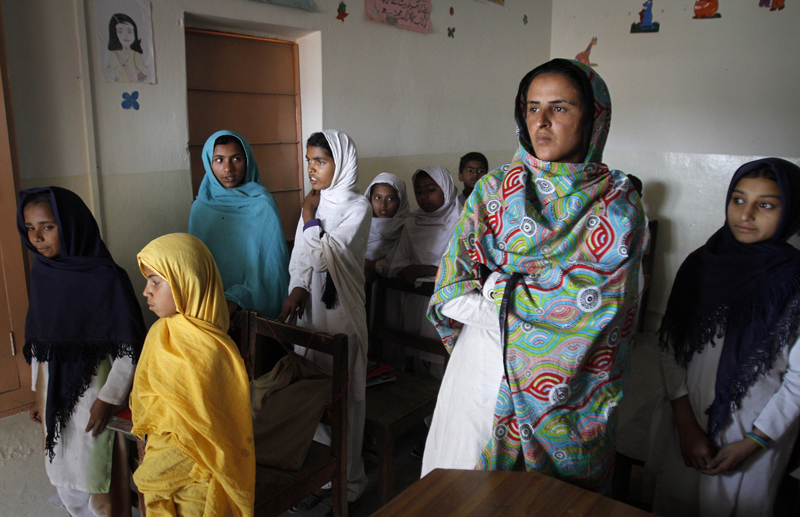 Mukhtaran Mai, second right, stands amongst students in a school which she established in Meerwala, located in the Muzaffargarh District of Pakistan's central Punjab province on April 23, 2011. Mai, a Pakistani victim of a village council-sanctioned gang-rape, who became a symbol of the country's oppressed women, said on Thursday her life was in danger after the Supreme Court acquitted 13 men accused of the crime. Photo courtesy of REUTERS/Stringer