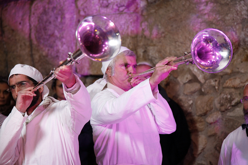 Kohanim, wearing their priestly garments, blow silver trumpets made by the Temple Institute for use in the Third Temple. Photo courtesy of Temple Institute