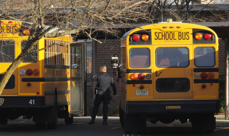 A police officer speaks with a school bus driver at the entrance of Marlboro Elementary School at Marlboro Township in New Jersey, January 3, 2013. Photo courtesy REUTERS/Eduardo Munoz