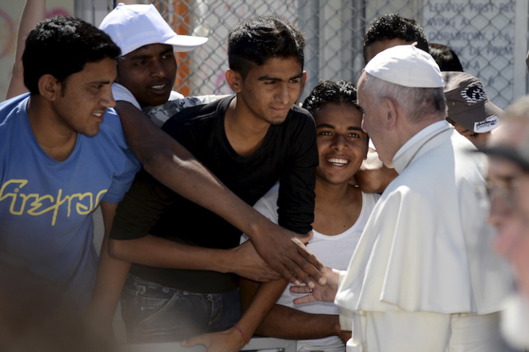 Pope Francis greets migrants and refugees at the Moria refugee camp near the port of Mytilene, on the Greek island of Lesbos, April 16, 2016. Photo courtesy REUTERS/Filippo Monteforte
