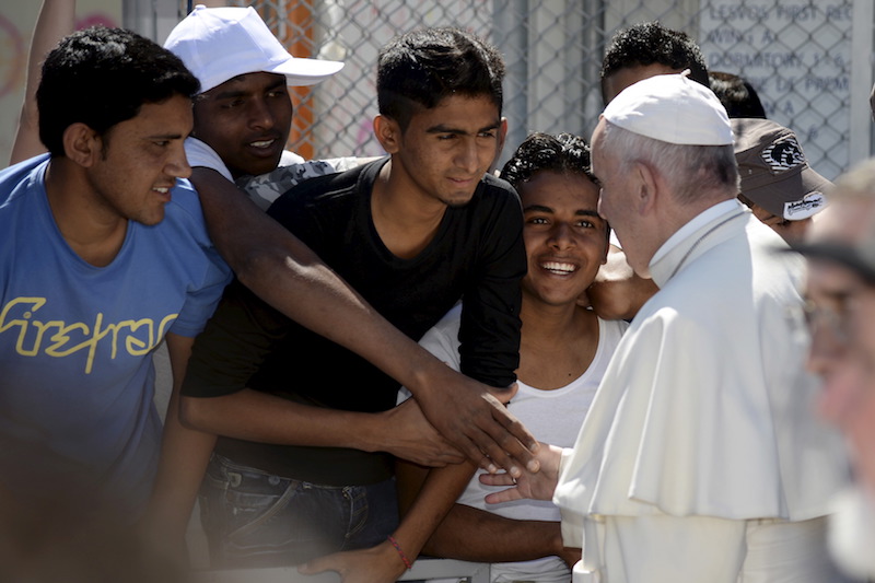 Pope Francis greets migrants and refugees at the Moria refugee camp near the port of Mytilene, on the Greek island of Lesbos, April 16, 2016. (Filippo Monteforte/Pool Photo via AP)