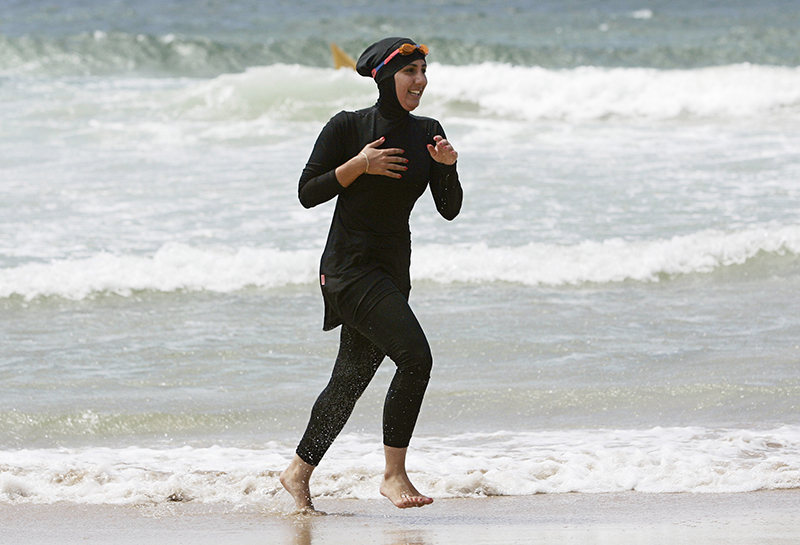 Twenty-year-old trainee volunteer surf life saver Mecca Laalaa runs along North Cronulla Beach in Sydney during her Bronze medallion competency test on January 13, 2007. Specifically designed for Muslim women, Laalaa's body-covering swimming costume has been named the "burkini" by its Sydney based designer Aheda Zanetti. Photo courtesy of REUTERS/Tim Wimborne *Editors: This photo may only be republished with RNS-BURKINI-SWIM, originally transmitted on April 6, 2016.