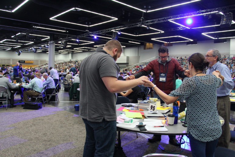 Delegates at the 2016 United Methodist General Conference in Portland, Ore., respond in prayer Wednesday (May 18) after hearing from Bishop Bruce Ough. RNS photo by Emily McFarlan Miller